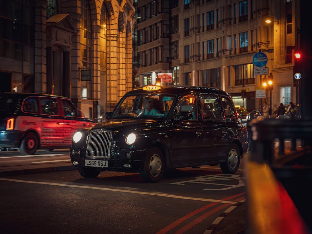 Black cab driving on a busy London street.